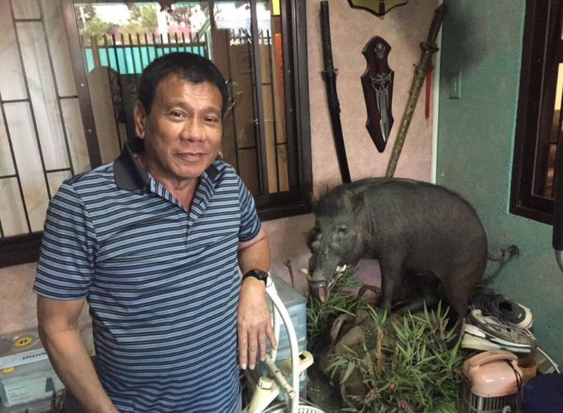 Duterte and the boar he shot 